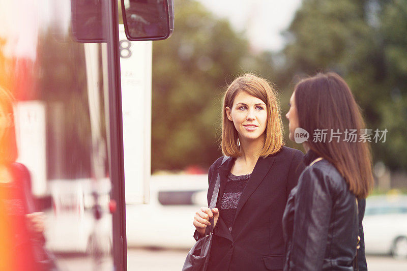 Young women waiting on the bus station